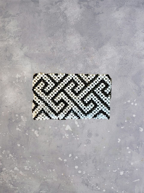 Black and white geometric beadwork on a slim bracelet