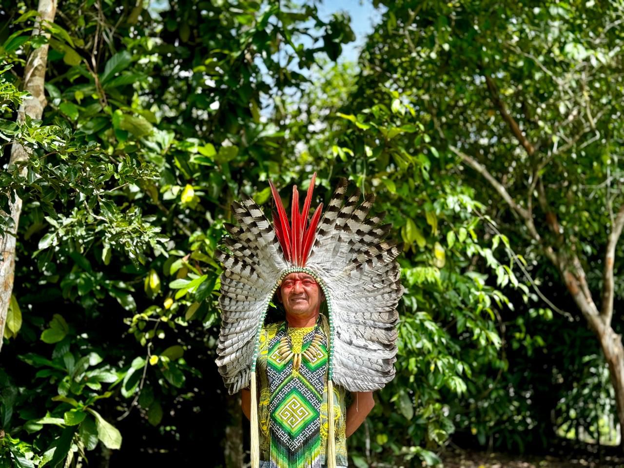 Chief Assis Kaxinawá of Aldeia Pinuyá in traditional feather headdress in the Amazon forest