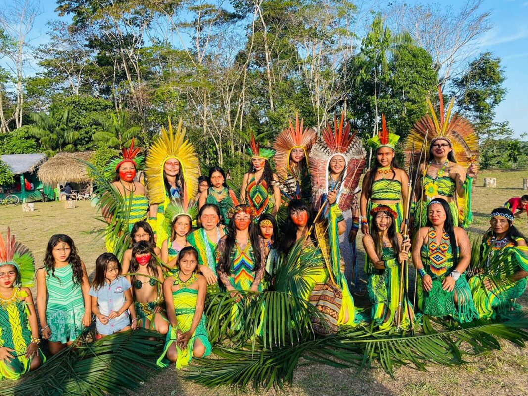 Huni Kuin people of Aldeia Pinuyá gathered in ceremonial dress with feather headdresses