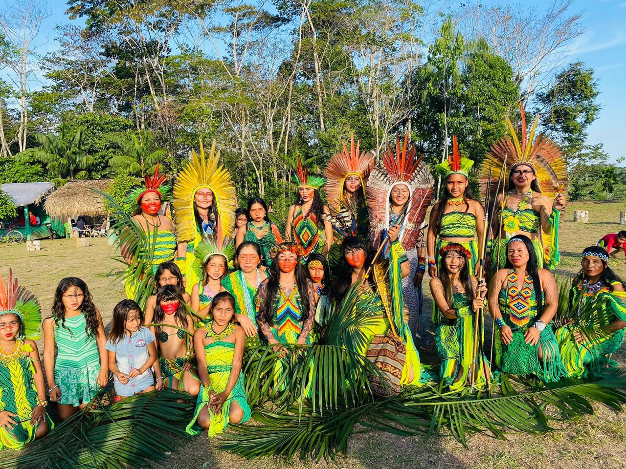 Huni Kuin people of Aldeia Pinuyá gathered in ceremonial dress with feather headdresses
